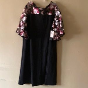 Black dress with multi colored on top and sleeves.